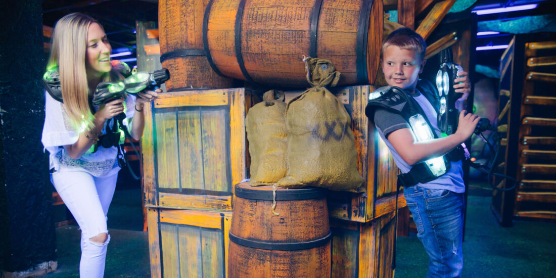 A mom and son play laser tag at Andy B's